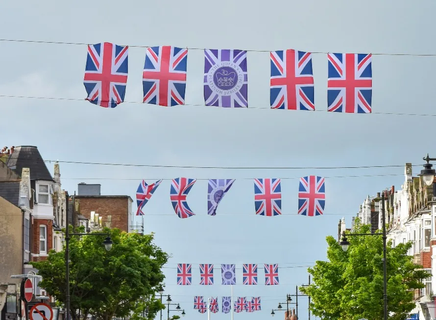 queen's jubilee flags shown over blue sky